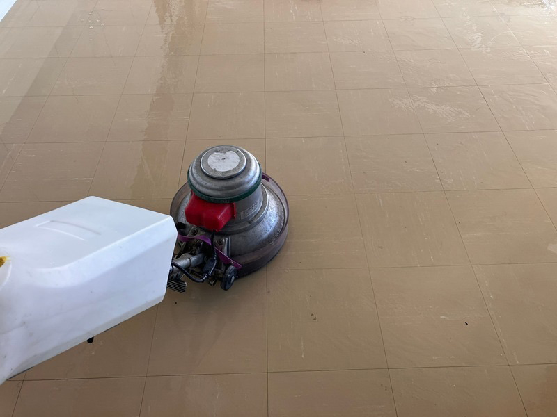 大規模施設の床に蓄積した黒ずみを業務用ポリッシャーで洗浄中