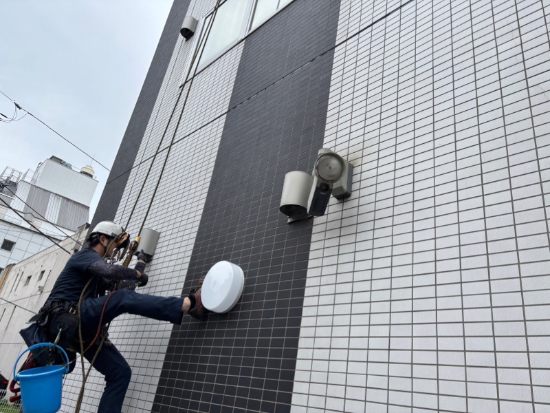 前橋市のオフィスビル外壁でロープアクセス作業を行うスタッフ